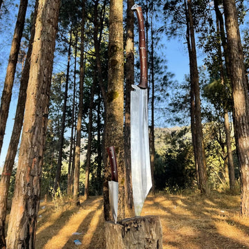 Two large knives embedded in a tree stump with a forest background